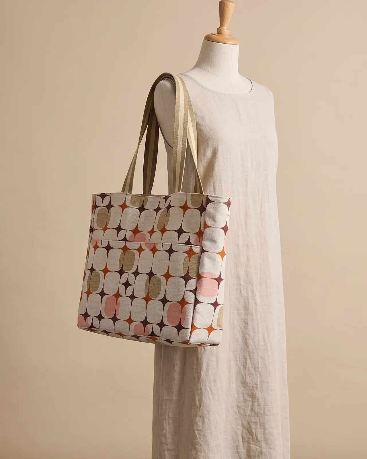 Large Tote Bag - Cream Retro Geometric worn on the shoulder on a display form