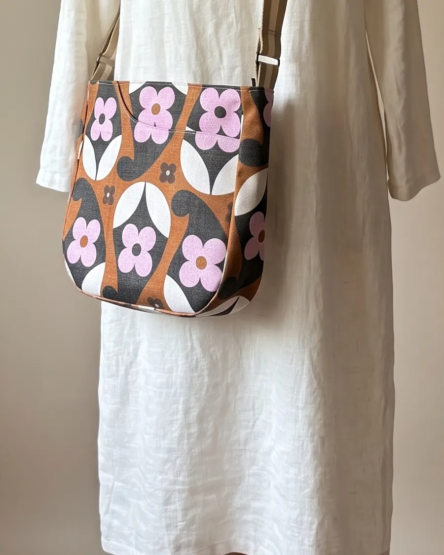 CrossBody Handbag - Brown Pink Retro Daisy worn crossbody on a display form