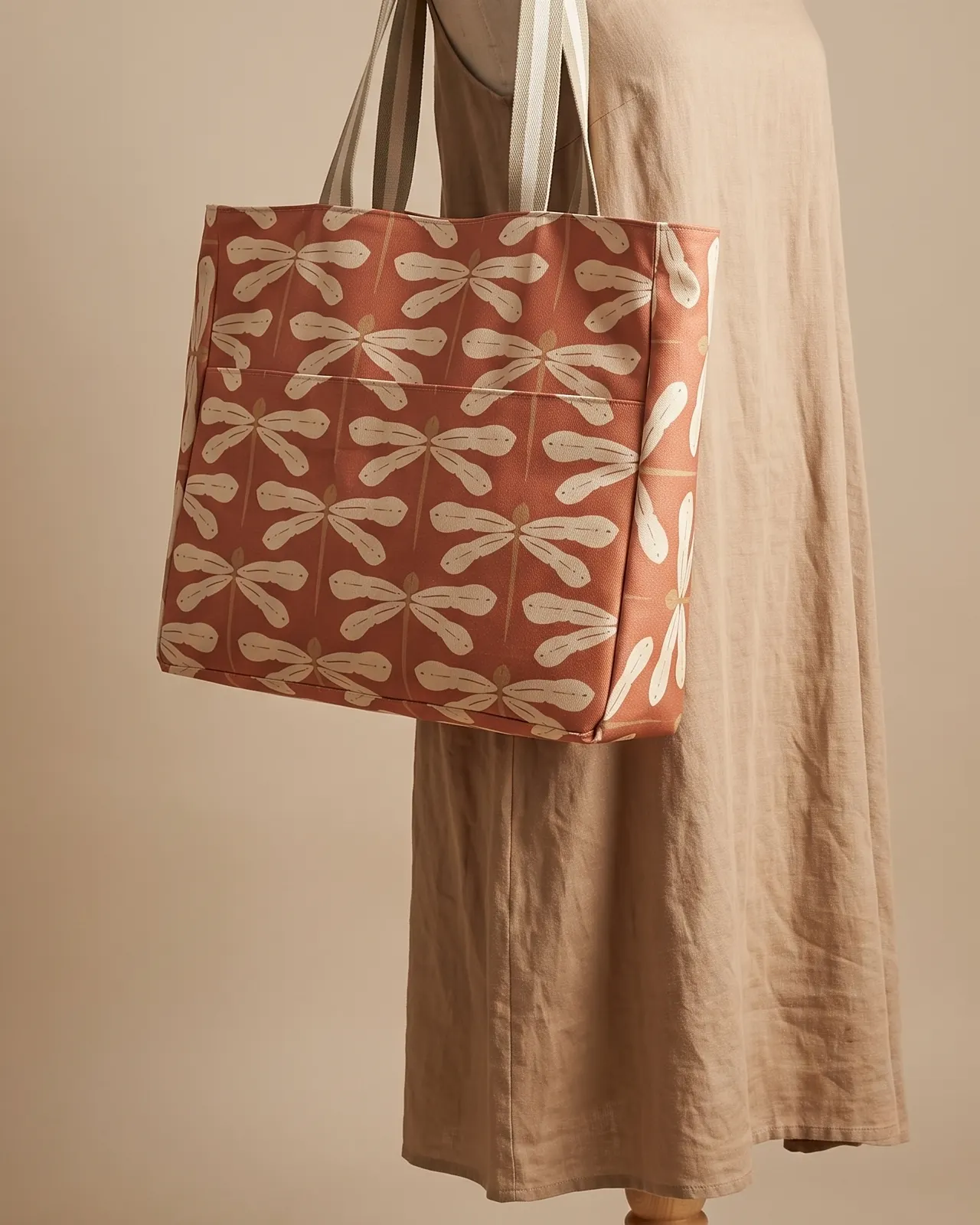 Large Tote Bag Zipper - Rust Dragonfly worn on the shoulder on a display form