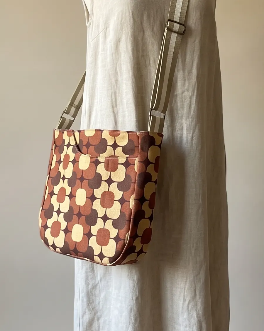 CrossBody Handbag - Brown Geometric Floral worn crossbody on a display form