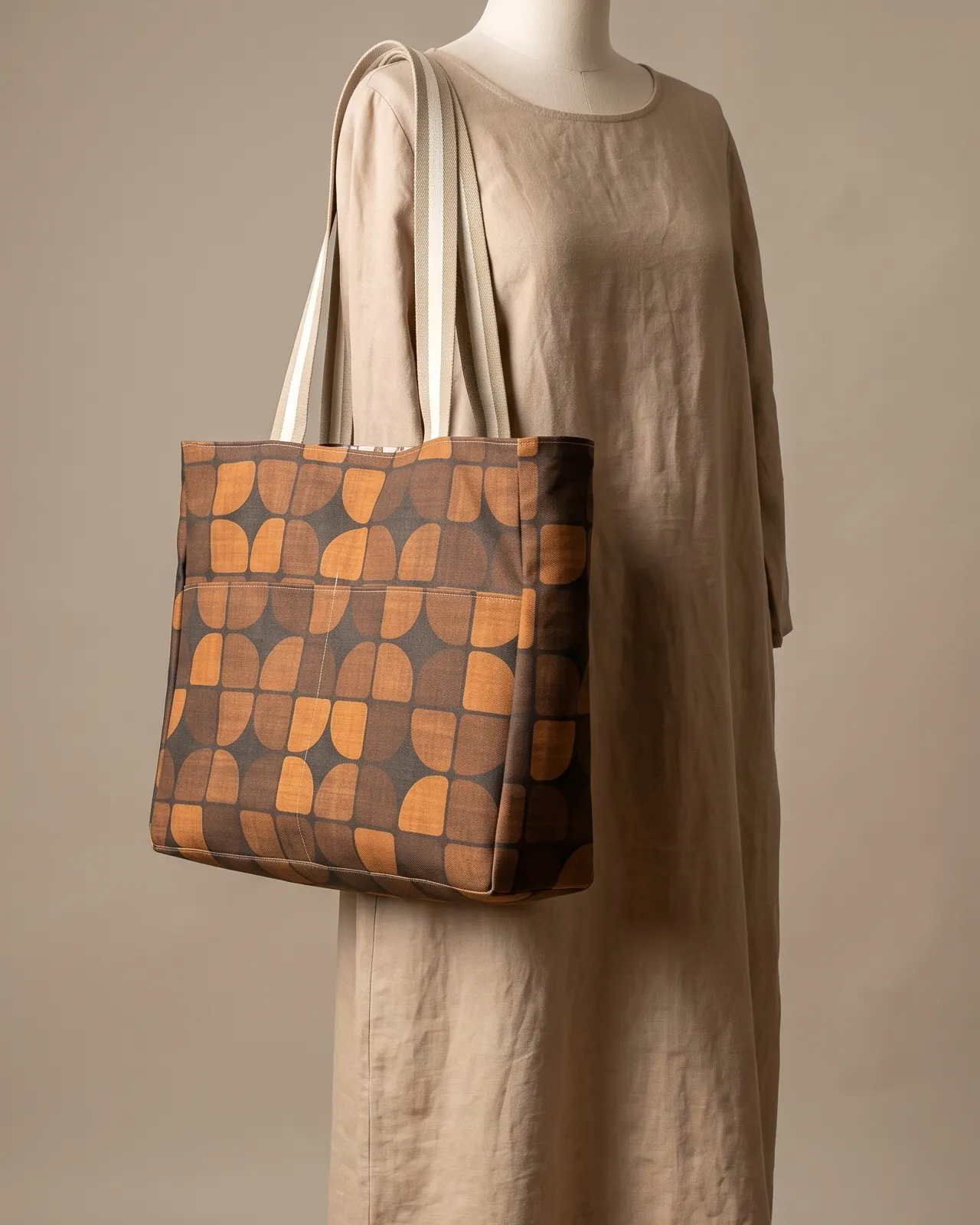 Large Tote Bag - Brown Geometric worn on the shoulder on a display form