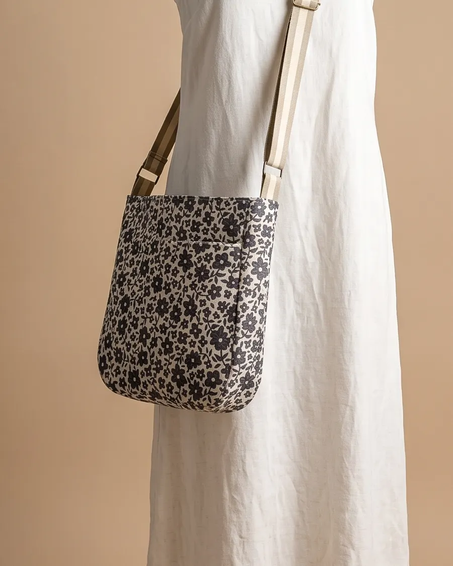CrossBody Handbag - Cream Ditsy Floral worn crossbody on a display form