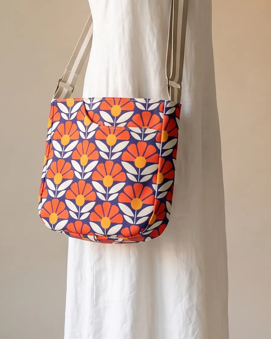 CrossBody Handbag - Navy Red Retro Floral worn crossbody on a display form