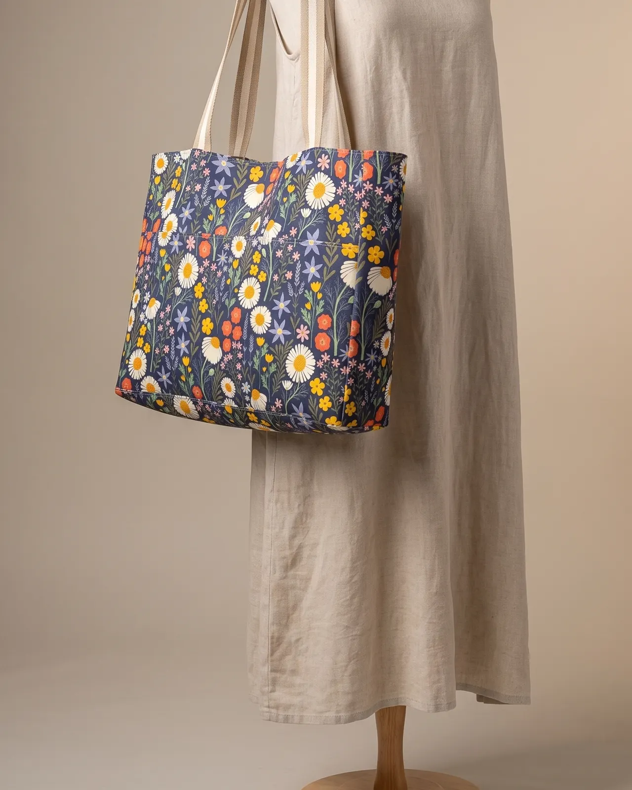 Large Tote Bag Zipper - Navy Wildflower Floral worn on the shoulder on a display form
