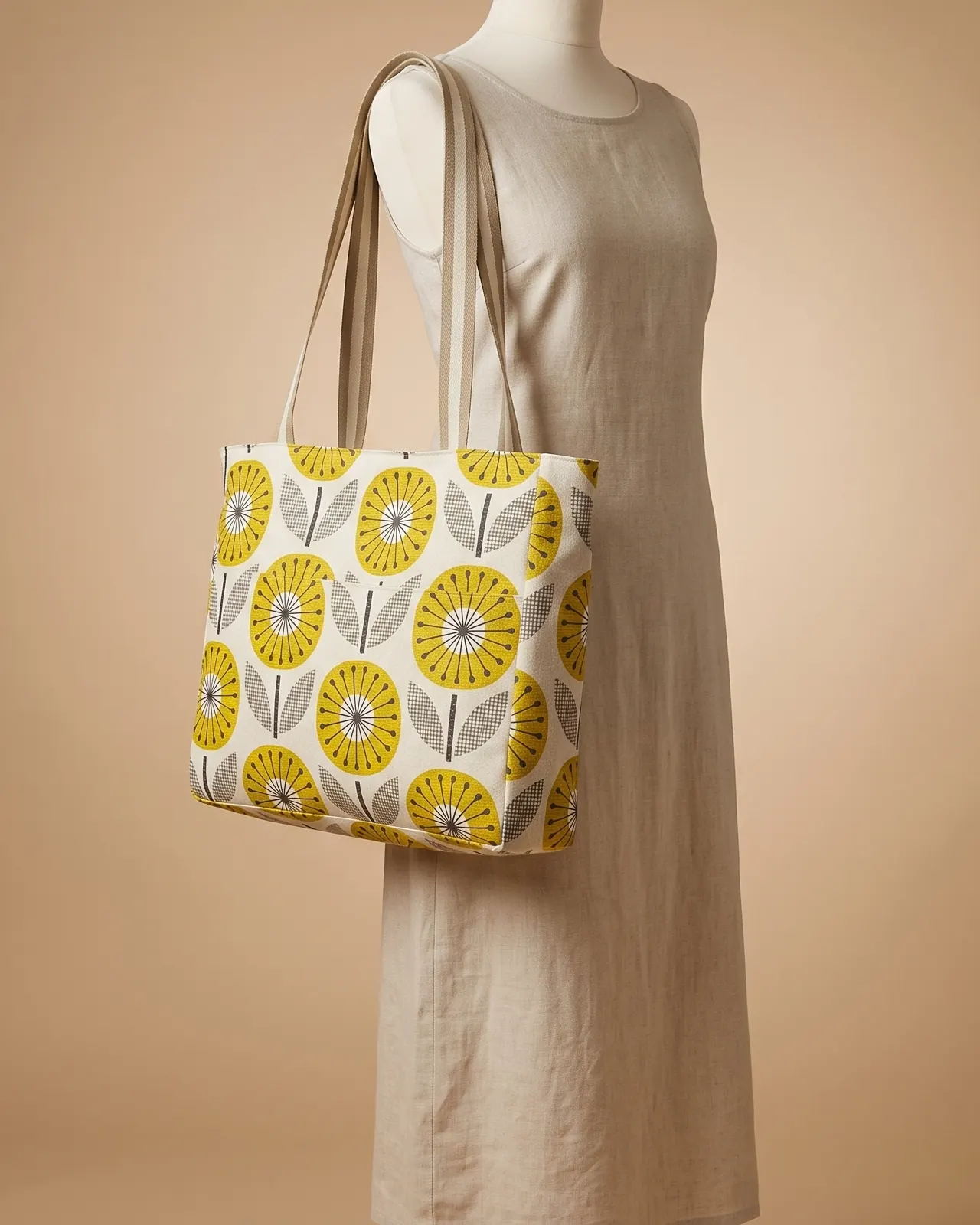 Large Tote Bag Zipper - Cream Mustard Geometric Floral worn on the shoulder on a display form