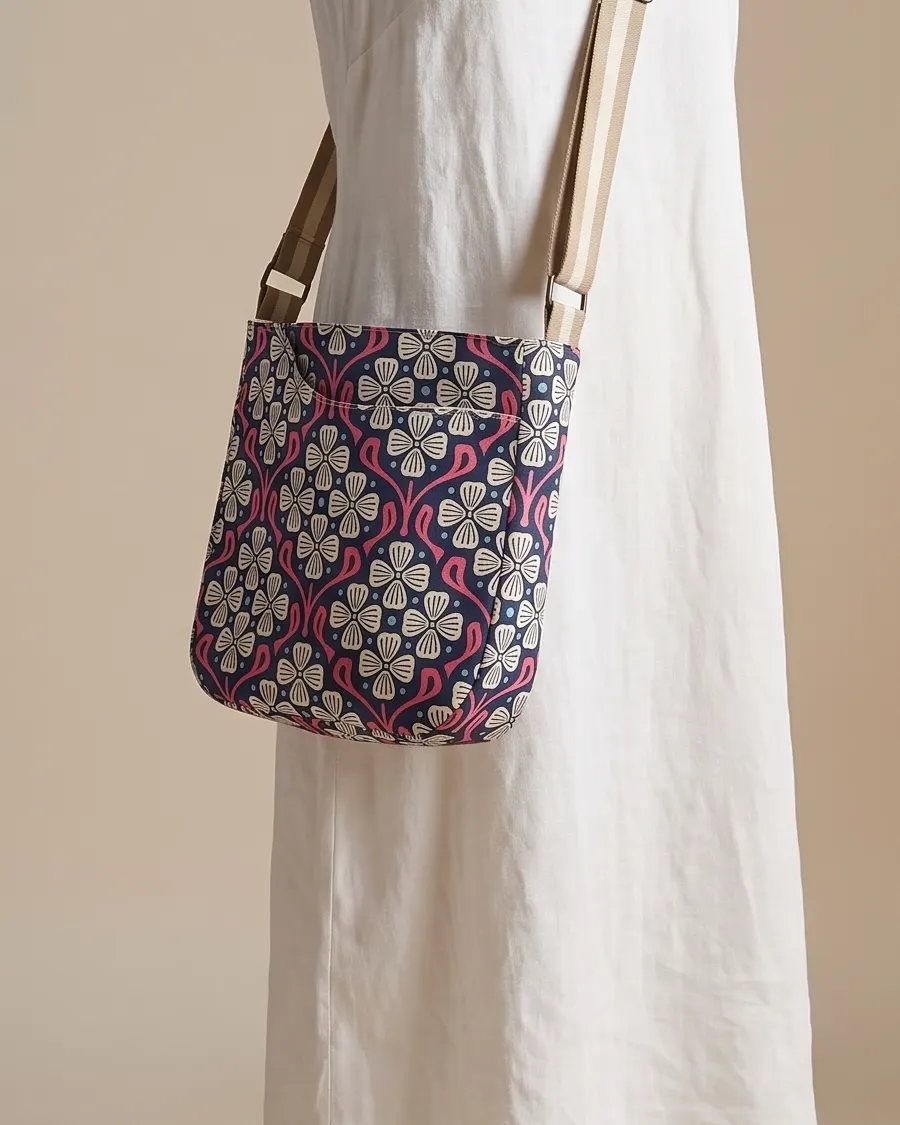 CrossBody Handbag - Navy Pink Floral worn crossbody on a display form
