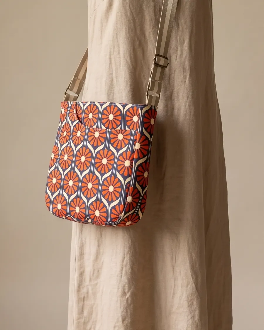 CrossBody Handbag - Retro Red Daisy worn crossbody on a display form