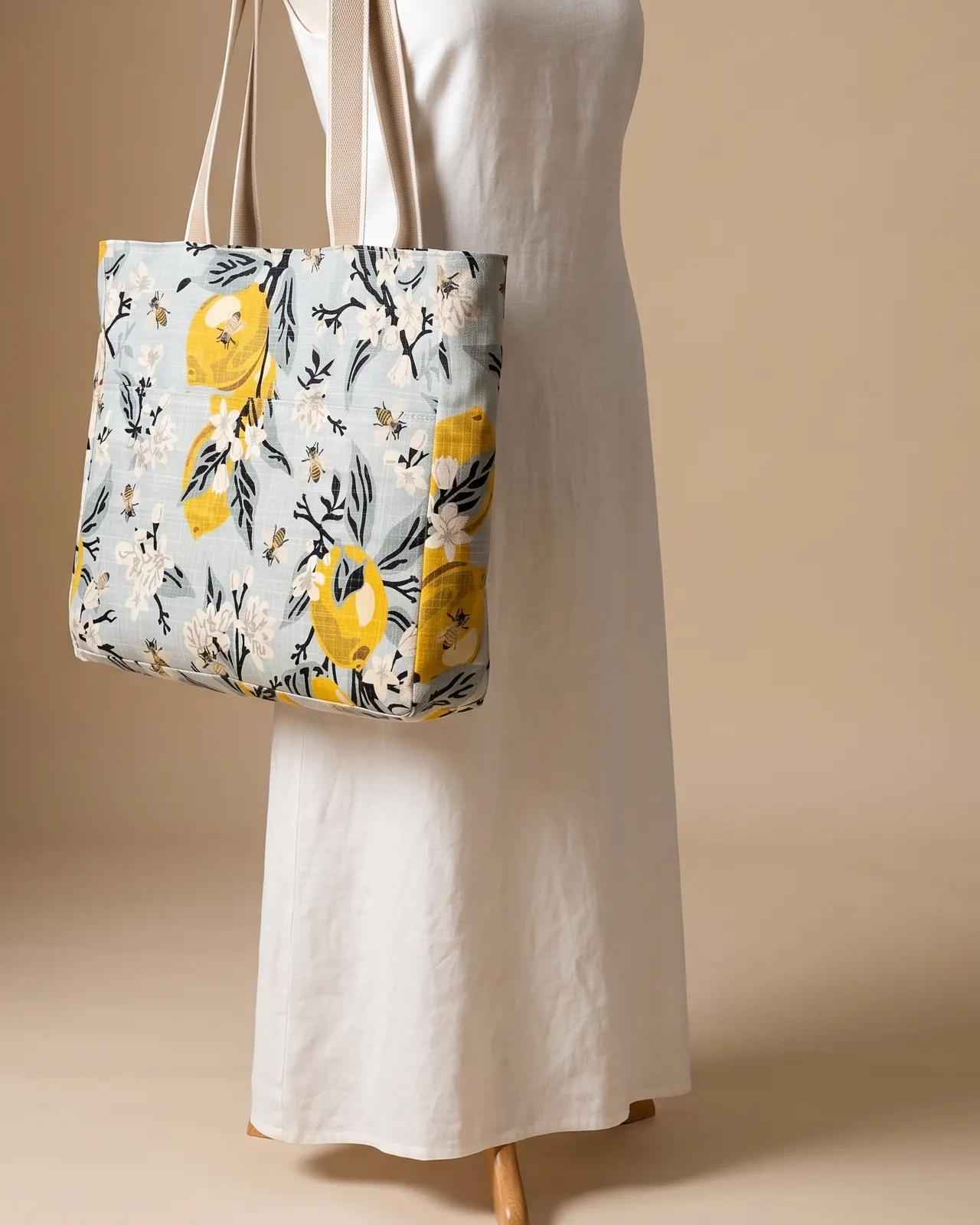 Large Tote Bag Zipper - Lemons & Bees worn on the shoulder on a display form